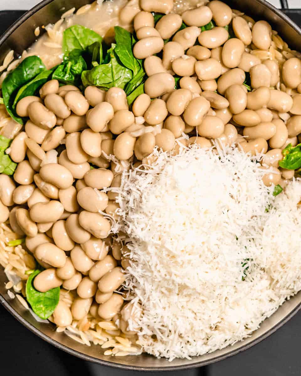 All ingredients for this lemon spinach orzo in a pan.